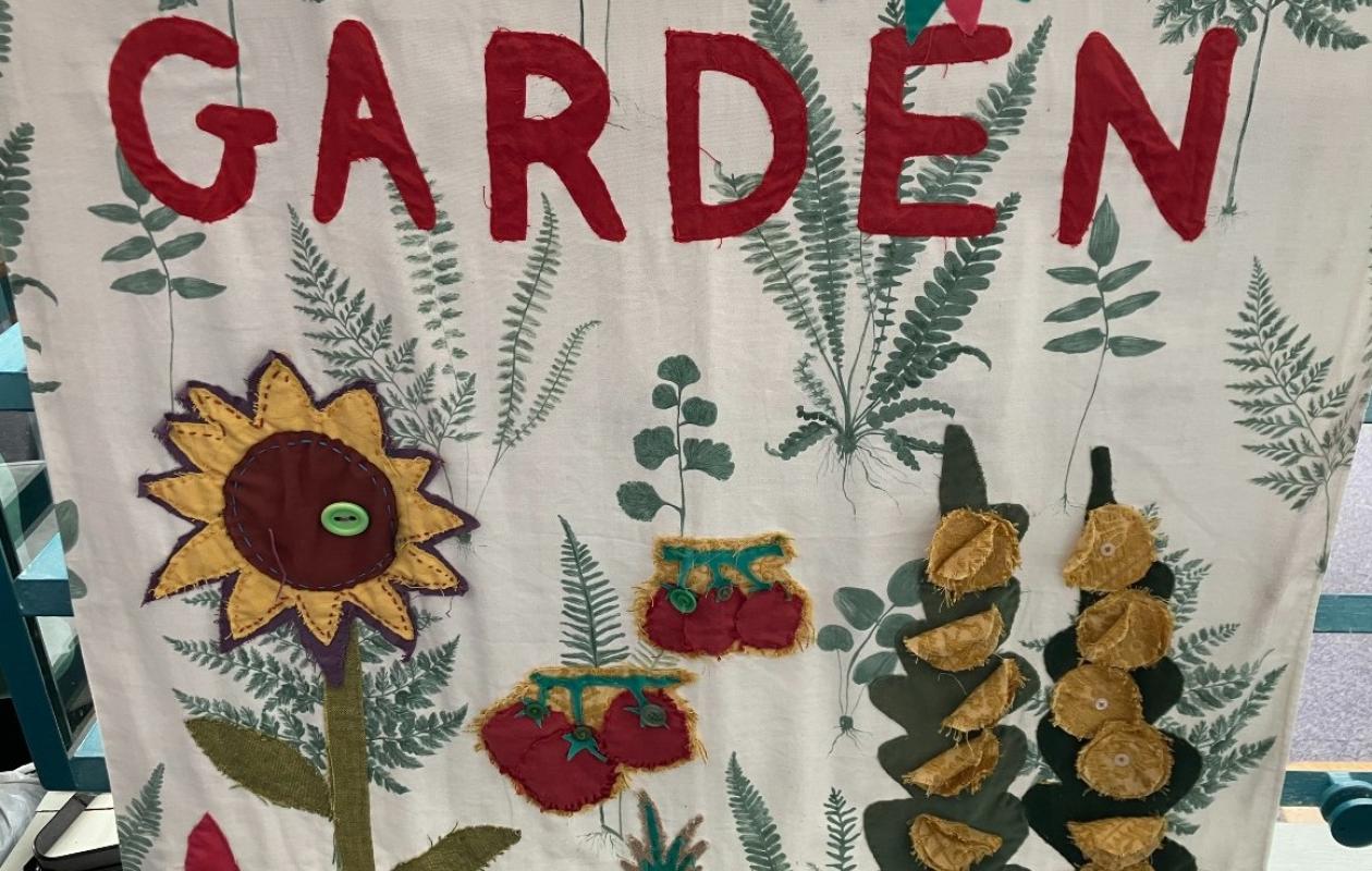 fabric banner garden sign with embroidered flowers and leaves 